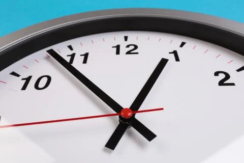 Closeup wall clock set on blue background. The concept of " The time is going Foto stock