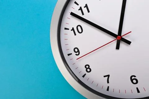 Closeup wall clock set on blue background. The concept of " The time is going 스톡 사진