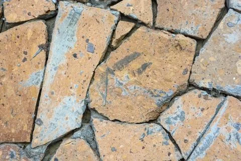 Closeup wall covered in pieces of stone background Stock Photos