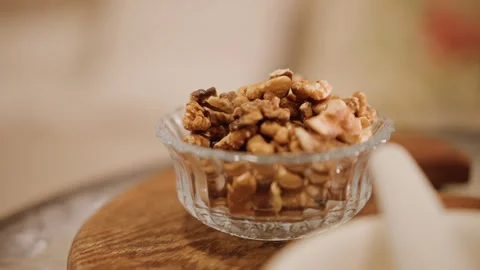 Closeup of walnuts in country kitchen. Focused image capturing glazed walnuts in Stock Footage 346394801