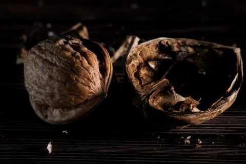Closeup of walnuts with a dark mood on a rustic wooden background. Foto stock