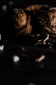 Closeup of walnuts with a dark mood on a rustic wooden background. Stock Photos