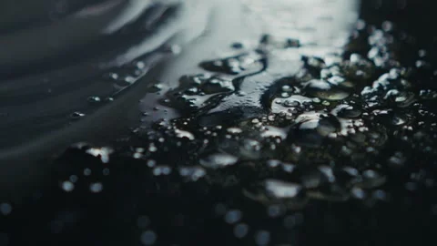 A CloseUp of Water Droplets on a Surface That Reflect Light Beautifully and Stock Footage 313287580