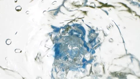 Closeup water falling down from bottle with drops splashing, slow motion video Stock Footage 153662297