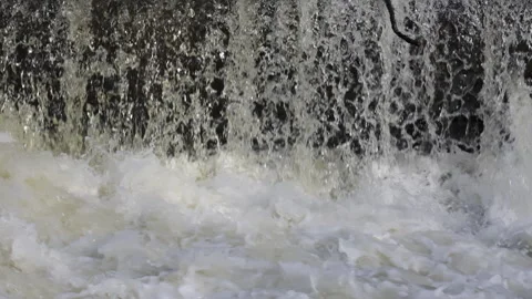Closeup of water falling down at a river in slow motion Stock Footage 271381447