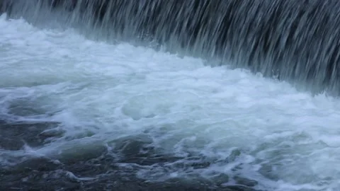 Closeup of water falling from river weir and simmering underneath. Water flowing Stock Footage 135270463