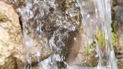 Closeup of water falling from rocks into pool 動画素材 73376197