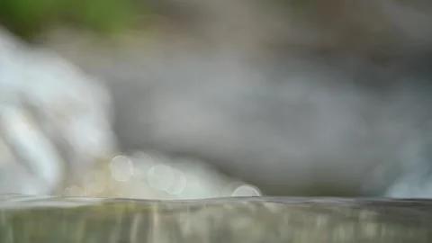 Closeup of water from a mountain river before it falls and nice bubble bokeh Video stock 212738623