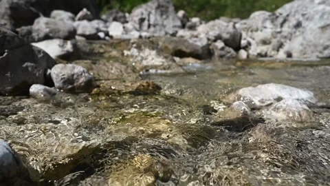 Closeup of water from a mountain stream flowing over stones (slow motion) Stock-Footage 260844613