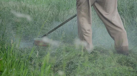 Closeup water rain dew drops rise from cutter mow trim wet grass Stock Footage 33729196