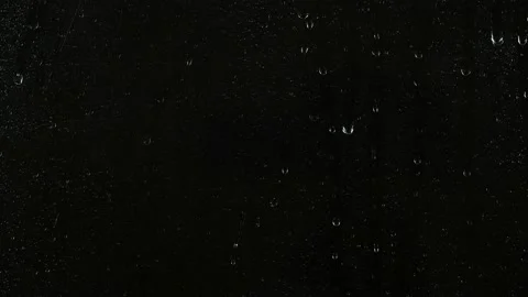 Closeup water rainfall, rain drops falling on window glass over black background Video stock 170811339