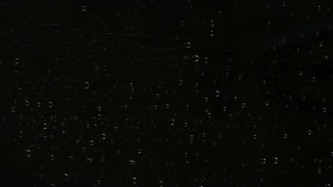 Closeup water rainfall, rain drops falling on window glass over black background Stock Footage 171441281