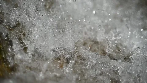 Closeup of water running over a rock in summer sunlight (slow motion, bokeh) Stock-Footage 219635477