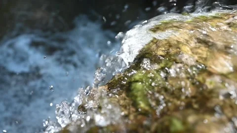A closeup of water running over rocks (in slow motion) Stock Footage 219646880
