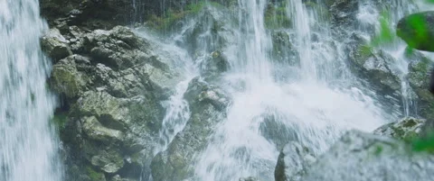 Closeup on waterfall crashing into rocks Stock Footage 248642835
