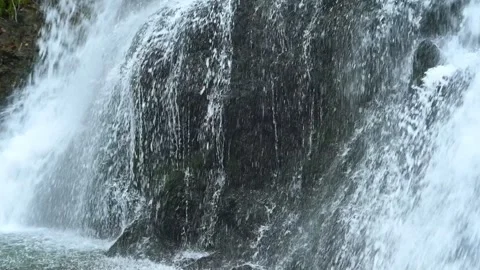 Closeup of a waterfall flowing over mossy stones, slow motion 스톡 동영상 288148925