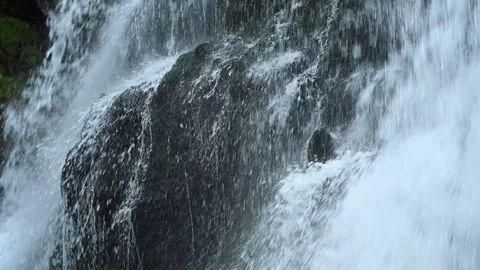 Closeup of a waterfall flowing over mossy stones, slow motion 스톡 동영상 288149161