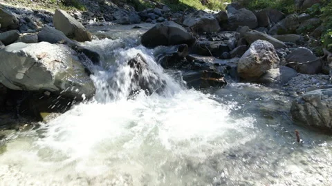 Closeup of waterfall, flying over the water in river. Beautiful clean water Stock Footage 153300596