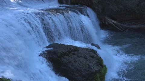 Closeup of a waterfall as it spills into a pool in a stream Stock Footage 40884352