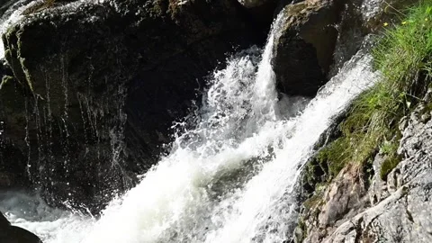 Closeup of a waterfall in the mountains (slow motion) Video stock 219352718