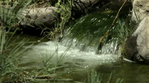 Closeup of a waterfall spilling into a pond Stock Footage 41541757