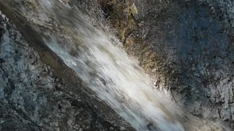 Closeup of a waterfall in a spotlight of the sun (slow motion) Stock-Footage 219645500