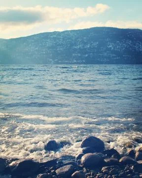 Closeup of waves on beach rocks Stock Photos