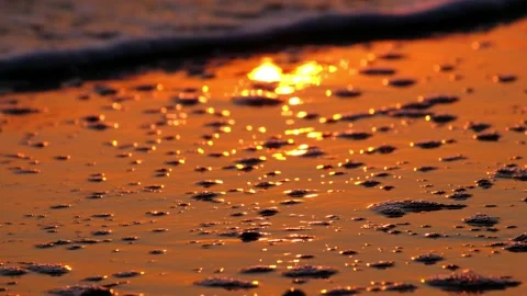 Closeup Waves on Sandy Beach with Sun reflection  on Sunset 4K Stock Footage 169145211