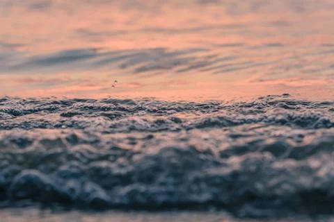 Closeup waves in the sunset Stock Photos