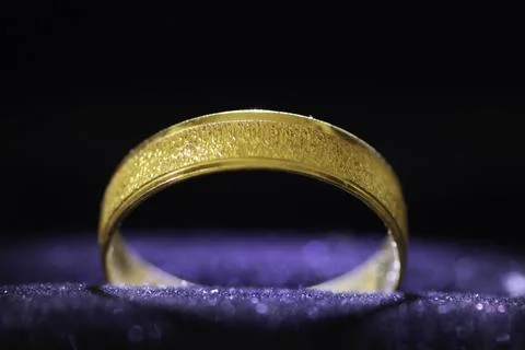 A closeup wedding ring on a blue background Stock Photos