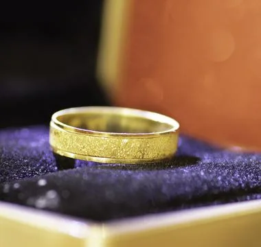 A closeup wedding ring inside a gift box Stock Photos