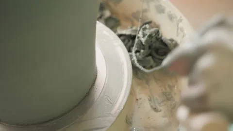 Closeup of wet clay being textured during pottery creation. Studio lighting Stock Footage 345523905