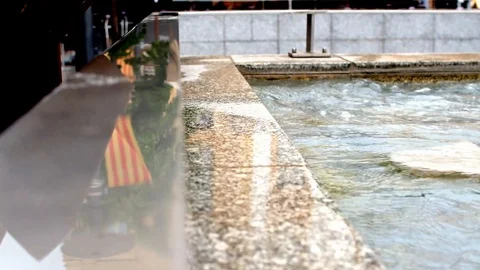 Closeup of a wet stone surface on a city square by a fountain in Perpignan. Stock Footage 101347037