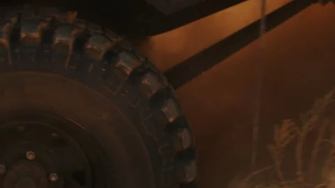 Closeup of wheel an SUV climbing up sandy road in desert, camera is taken aside Stock Footage 199972847
