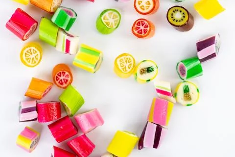 Closeup on white background in a small multi-colored sugar caramels with Stock Photos