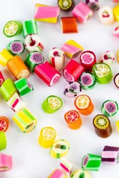 Closeup on white background in a small multi-colored sugar caramels with Stock Photos