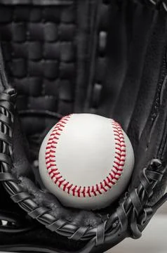 Closeup of a white baseball ball inside baseball glove Stock Photos