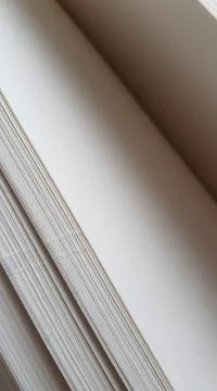 Closeup white blank sheets of thick notepad paper. Stock Photos