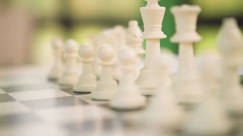 Closeup white chess pieces arranged on checkered board with soft lighting Stock-Footage 346650106
