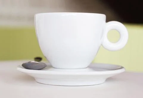 Closeup, white cup and saucer in cafe, coffee shop and order for hot drinks Stock Photos