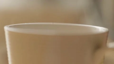 Closeup of white cup with hot drink. Steam from cup closeup. Hot coffee. Stock Footage 131579907