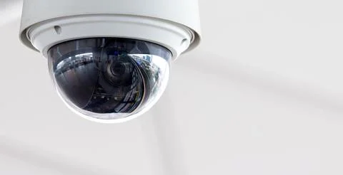 Closeup of white dome type cctv digital security camera installed on ceiling Stock Photos
