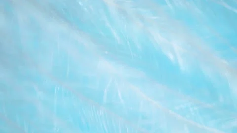 Closeup white fluffy feather texture on blue abstract background, blurred motion Stock-Footage 156885978