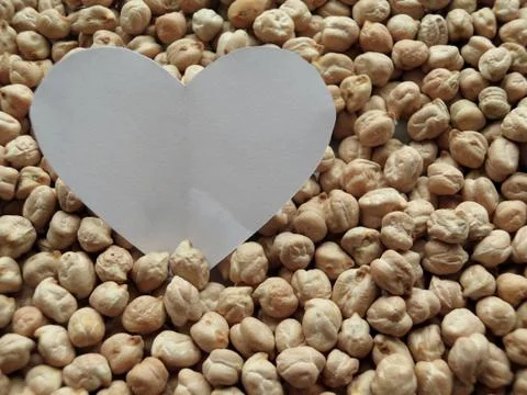 Closeup of White Heart shape on pattern of chickpeas. healthy food Stock Photos