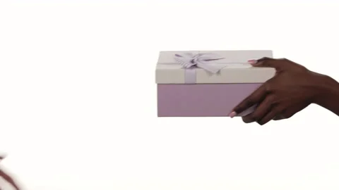Closeup of a white man's hand getting a gift box from a black woman's hand. Stock-Footage 171480027