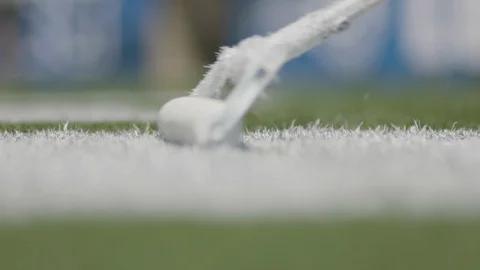 Closeup of white paint being painted on football field Stock Footage 105426049