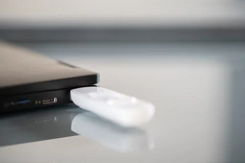Closeup of white pendrive connected to USB port Stock Photos