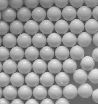 Closeup of white plastic bb's lined up on flat background Stock Photos