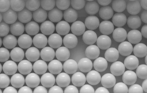Closeup of white plastic bb's lined up on flat background Stock Photos