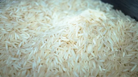 Closeup white rice pile falling in slow motion Stock Footage 104712772
